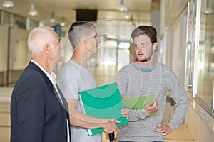 Professor talking to students in corridor