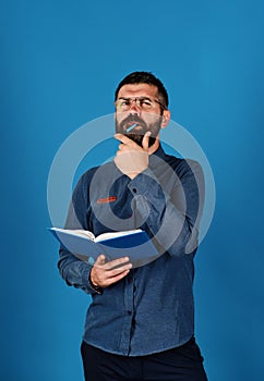 Professor with thinking face. Textbook in blue color