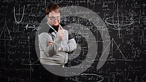 Professor writes equation on blackboard full of mathematics formulas and points finger smiling