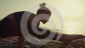 Proffesional yoga woman leaning on hands firefly position at sunset close up.