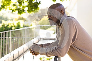 Profile of african american senior man on sunny terrace