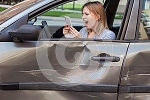 Profile of angry despaired female with blonde hair holding smart phone in hands and screaming loudly while calling to insurance