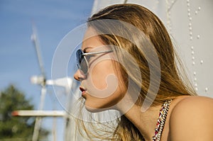 profile attractive girl with long hair in sunglasses about helicopter outside