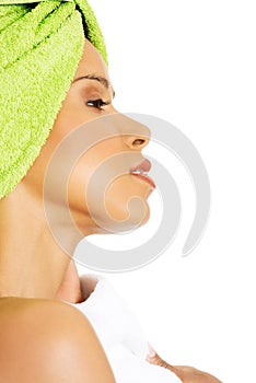 Profile of attractive woman wrapped in towel with turban.