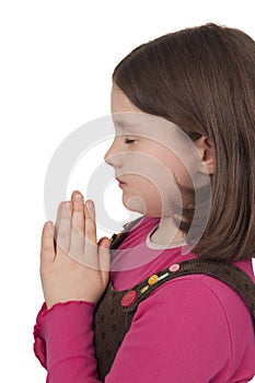 Profile of beautiful girl praying with closed eyes