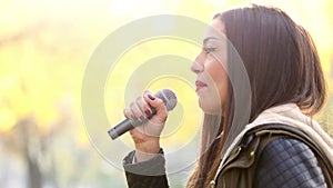 Profile of beautiful woman singing