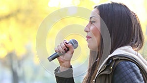 Profile of beautiful woman singing
