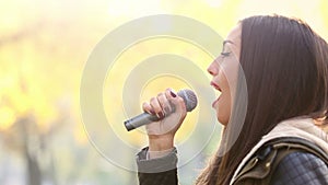 Profile of beautiful woman singing