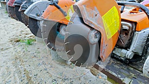 Profile on the blade of an asphalt or concrete cutter and workers boots Profile on Asphalt Cutter Profile