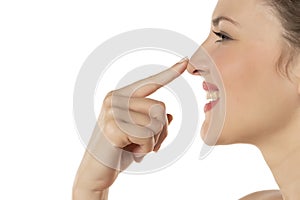 Profile of a blonde smiling woman touching her nose