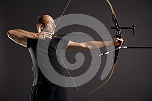 Profile of bowman with bow and arrow.