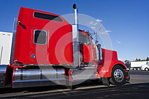Profile of bright red American big rig semi truck with chrome ac