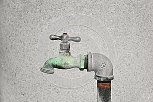 profile of a bronze metallic faucet outdoors