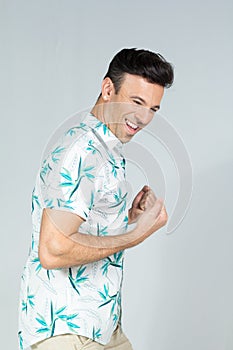 Profile of celebrating man. Handsome brazilian male wears summer