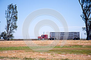 Profile of classic red rig semi truck with trailer for transport