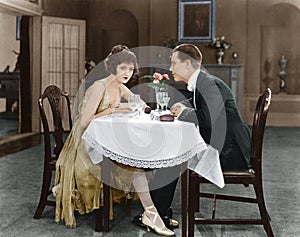 Profile of a couple sitting at a table