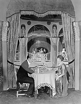 Profile of a couple sitting at a table in a restaurant having dinner