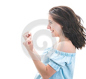 Profile of excited young woman with closed eyes and clenched fists, isolated on white background. Yes concept. Good news. Pretty