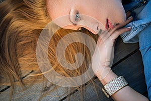 Profile fashion portrait of strict red-haired girl