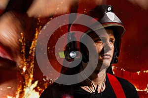 Profile of a firefighter equipped in a helmet and flashlight, against a background of fire and flames.