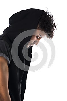 Profile of handsome tough young man in dark hoodie isolated