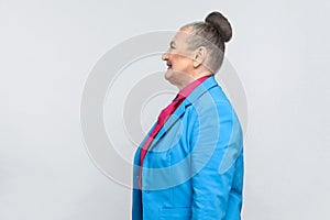 Profile of happiness aged woman with bun gray hair