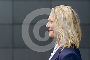 Profile head shot of a happy blond woman