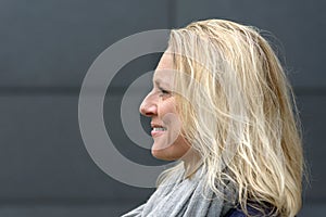 Profile head shot of a satisfied blond woman