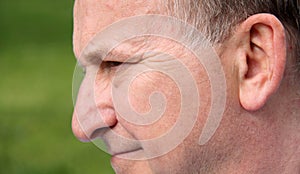 Profile of the human male face smiling close up