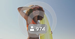 Profile icon with increasing numbers against woman with surfboard looking at a distance