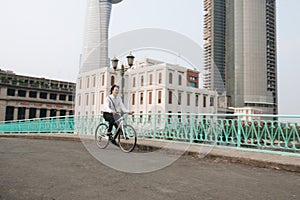 Profile image of an active businessman riding a bicycle on the way to job