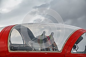Profile of jet plane cockpit against cloudy sky