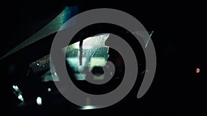 Profile of a man in car on dark night.