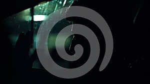 Profile of a man in car on dark night.
