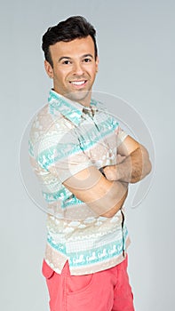 Profile of man with crossed arms. Handsome brazilian male wears