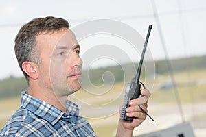 Profile man using walkie talkie