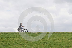 Profile of middle aged woman riding bike photo