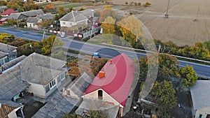 A profile moving aerial establishing shot of a typical small town at sunset.