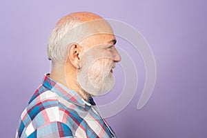 Profile of old mature senior man with grey beard on black studio background. Older grandfather, grandpa pensioner
