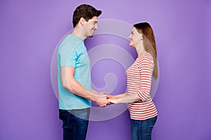 Profile photo of adorable guy lady couple standing opposite holding hands looking eyes love confession wear casual blue