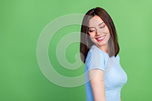 Profile photo of adorable satisfied girl toothy smile look empty space isolated on green color background