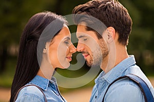 Profile photo of amazing pair going to kiss contacting noses closing eyes wear denim outfit