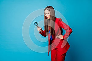 Profile photo of attractive business lady holding enlarge loupe searching piece of evidence wear luxury trend red suit