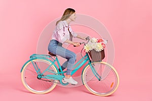 Profile photo of cheerful lady ride bike deliver flowers hurry shopping concept wear jacket isolated pink color