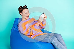 Profile photo of excited addicted girl have fun playing games open mouth smile isolated on blue color background