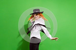 Profile photo of funky red hairdo millennial lady dance look wear shirt trousers hat isolated on green background