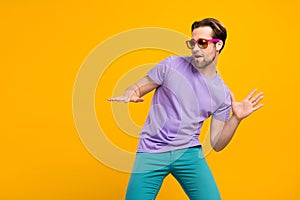 Profile photo of funny cool dj guy play popular track wear sunglass purple t-shirt isolated yellow color background