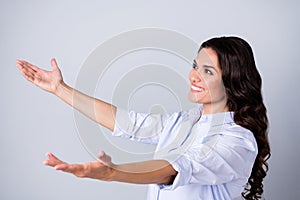 Profile photo of hopeful lady stretch hands catch empty space presents wear blue shirt isolated grey color background