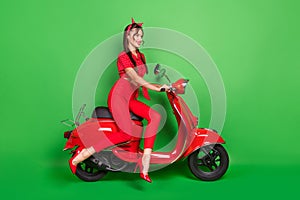 Profile photo of lady drive scooter wear dotted blouse headband trousers high-heels isolated green color background