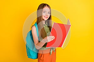 Profile photo of nice blond little girl read book wear bag khaki blouse  on yellow color background